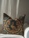 Square pillow cover featuring a stylized copper peacock design centered in a medallion, surrounded by Art Deco fan patterns and shell motifs on a dark forest green background.